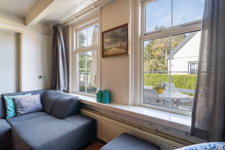 Vakantiehuisje Even Bykomme woonkamer zithoek uitzicht
