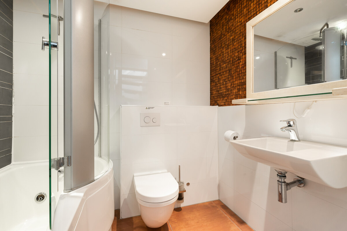 badkamer met douche, ligbad en toilet van het ondina huisje op schiermonnikoog